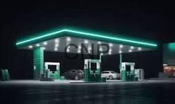 Nighttime gas station with green pumps and turquoise neon roof lights, a few cars parked at the islands.