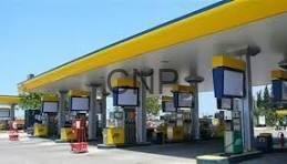 fuel - Center News Network CNPC gas station with several fuel pumps beneath a yellow canopy on a sunny day.