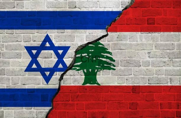Israel and Lebanon flags together Israel and Lebanon conflict - Center News Network Wall painted with the Israeli flag on the left and the Lebanese flag on the right, cracked down the middle.