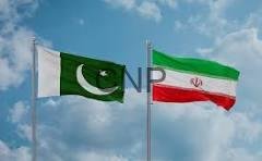 Two national flags waving in a clear blue sky: Pakistan on the left and Iran on the right.