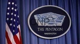 pentagon - Center News Network Seal of the Pentagon on a blue curtain backdrop with the U.S. flag to the left.