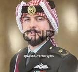 Portrait of a man with a beard wearing a red-and-white checkered turban and a formal military uniform with medals.