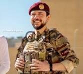 wal - Center News Network Smiling soldier in camouflage and maroon beret holds a large trophy during an award ceremony.