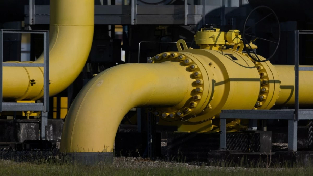 - Center News Network Yellow industrial pipeline with bolted flange connections at a processing facility, close-up view
