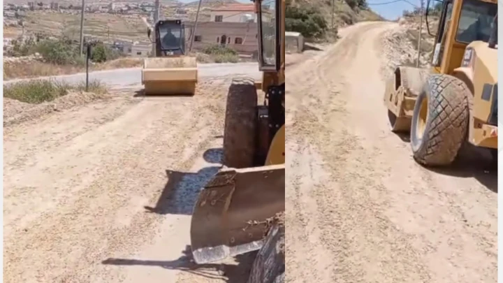- Center News Network Two construction vehicles on a dusty rural road: a road roller in the foreground and a wheel-loader behind it, leveling the dirt road.