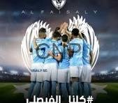 FAIS - Center News Network Soccer players in blue jerseys huddle on the field beneath a large white wing graphic with Arabic caption overlaid.