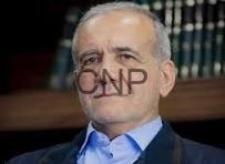 baz - Center News Network Portrait of a man in a blue shirt and dark blazer, seated indoors with a wooden bookshelf in the background (watermark 'CNP').