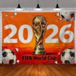 Orange promotional banner featuring the 2026 FIFA World Cup trophy with soccer balls on both sides and a bright orange background.