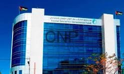 dammm - Center News Network Modern glass-fronted office building with blue-tinted windows, two flagpoles bearing flags, and a clear blue sky above.