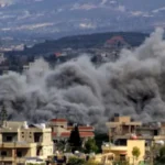 A large dark smoke plume rises over a residential neighborhood, suggesting an explosion or bombing in progress.