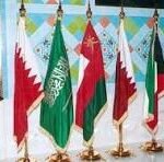 Row of colorful flags from different countries and organizations on gold poles displayed at a formal ceremony.