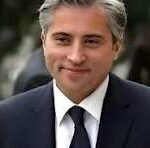 Man in a dark suit and tie, outdoors, with a neutral expression (watermark 'CNP' visible).