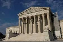 jus - Center News Network U.S. Supreme Court building with tall white columns and a triangular pediment on a sunny day.