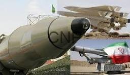 roch - Center News Network Two missiles on display outdoors: a large gray missile in the foreground and a smaller, flag-marked missile with a red tip in the background.