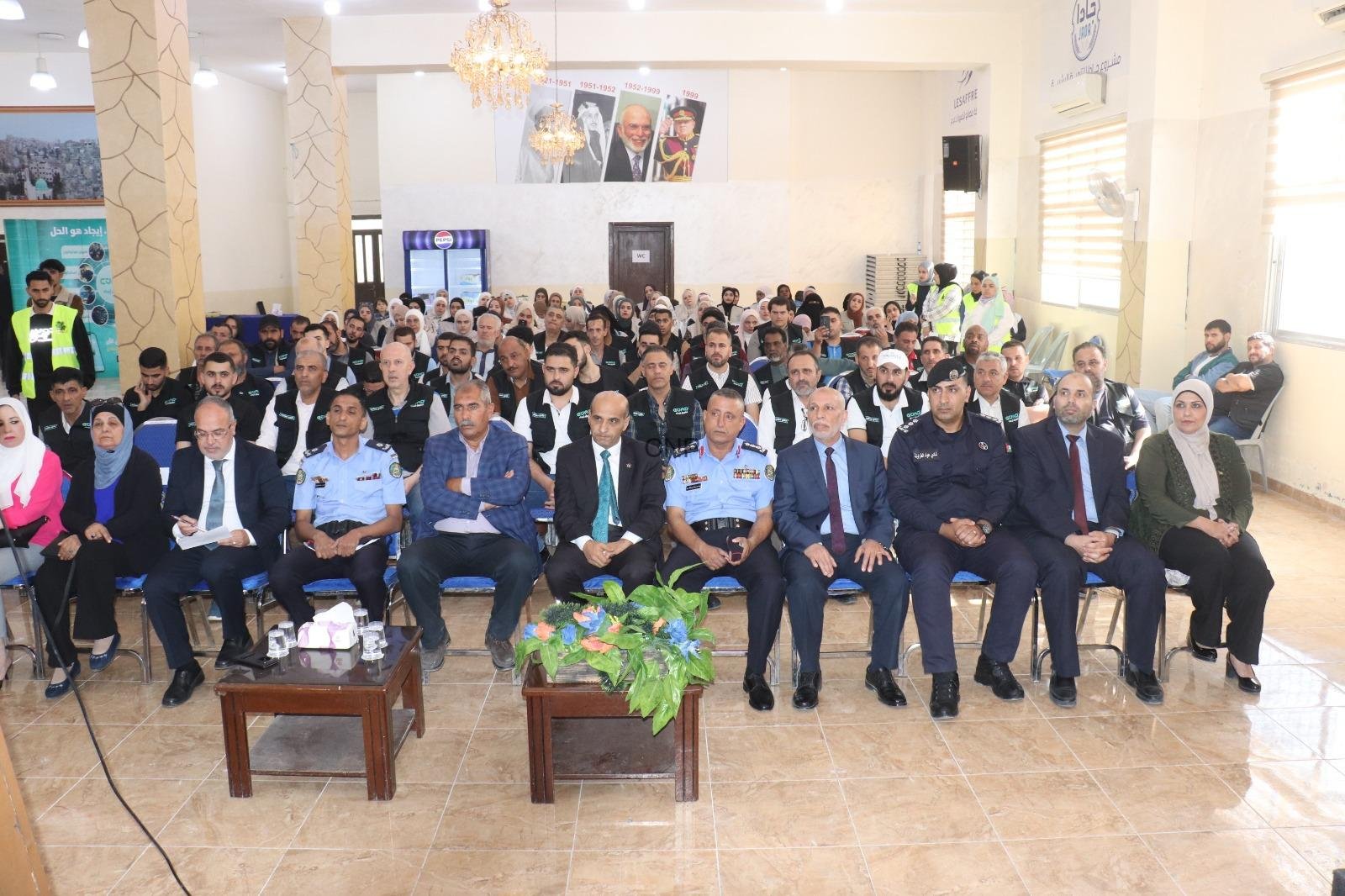rsi - Center News Network Large hall filled with people seated for a formal event; front row includes police officers in light blue uniforms.