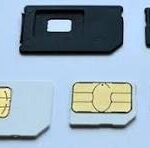 Several SIM cards and adapters laid out on a light blue surface, showing different SIM formats and gold contact pads, with 'CNP' text in the center.