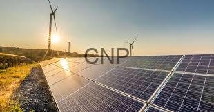 solar sys - Center News Network Solar panels in a field with wind turbines on the horizon at sunset, illustrating renewable energy.