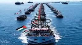 Flotilla of boats sailing in precise formation on a calm blue sea, lead ship flying an Indonesian flag.