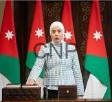 Woman at a podium giving an official briefing, with Jordanian flags behind her.