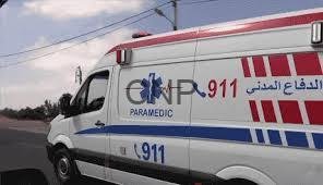 - Center News Network White ambulance with red and blue stripes and 911/Paramedic markings parked on a street, Arabic text visible on the side, suggesting emergency medical services.