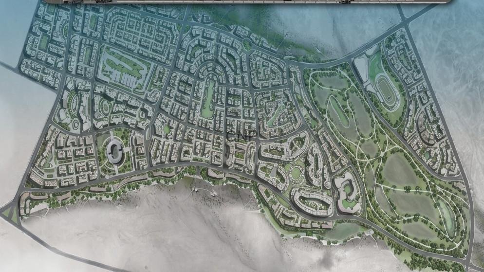 PARKAM - Center News Network Aerial view of a coastal city with dense streets and a large golf course to the east.