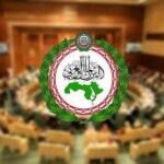 Emblem of the Afghan Parliament centered on a blurred parliamentary chamber background.