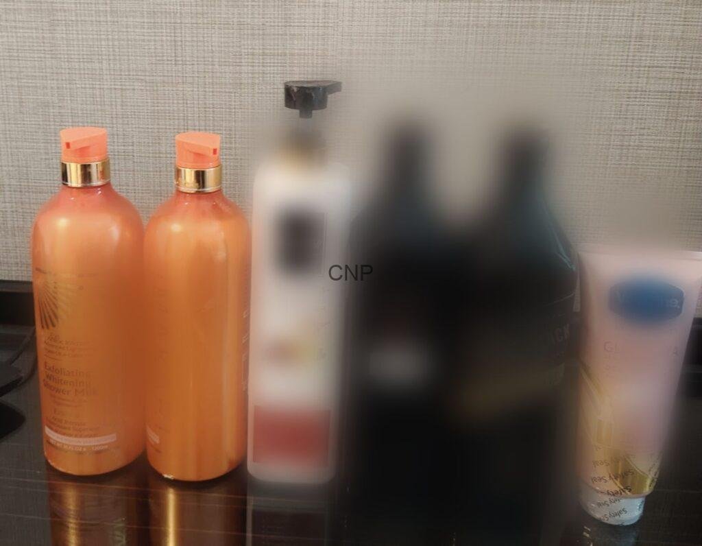 ddrrrr - Center News Network Three orange pump bottles on a bathroom shelf with blurred background bottles behind them.