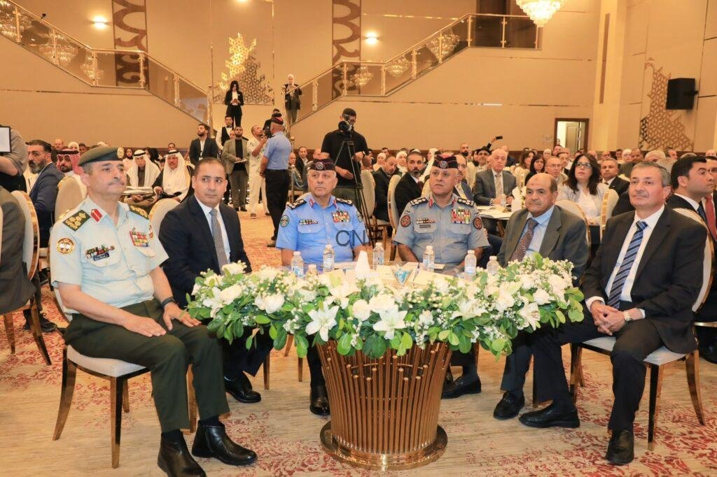 mok1 - Rakeen News Formal ceremony with military officers and civilians seated at a round table adorned with white flowers in a grand ballroom.