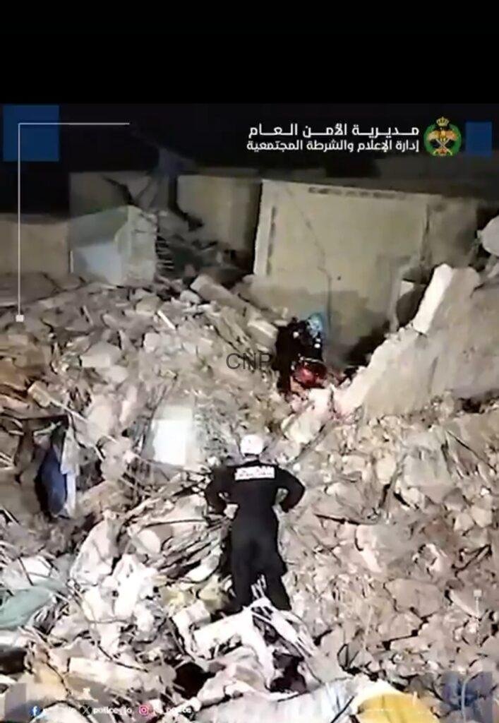 ss5 - Center News Network Nighttime rescue scene: responders search through a collapsed building with concrete rubble and debris.