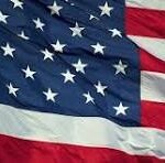 Waving United States flag with visible stars and red-and-white stripes, fluttering in the breeze.