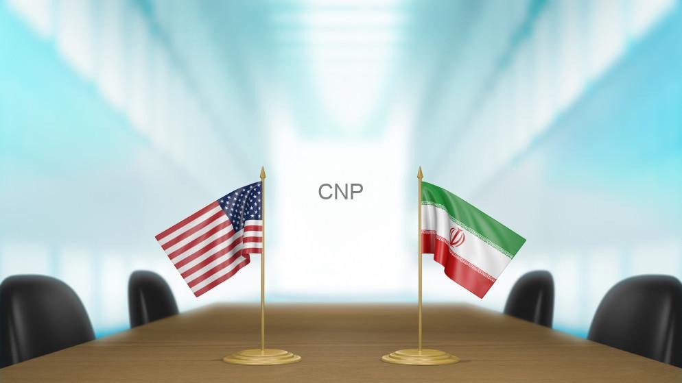 usir - Center News Network Two national flags (USA and Iran) mounted on a conference table in a bright meeting room, with 'CNP' displayed between them on a white screen.