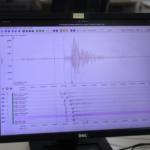 Dell monitor displaying an audio waveform analysis screen with multiple tracks and a yellow sticky note labeled Local on top.