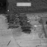 Aerial view of stacked metal scaffolding in a yard beside a building; compass N and a 4 m scale shown.