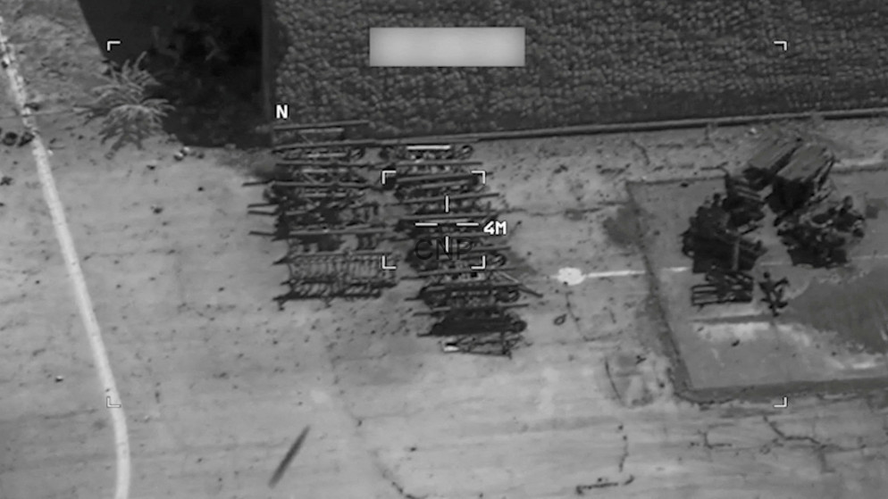 image - Center News Network Aerial view of stacked metal scaffolding in a yard beside a building; compass N and a 4 m scale shown.