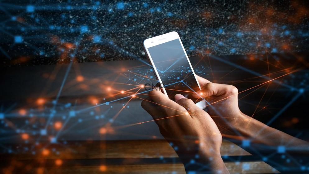 image - Center News Network Hands holding a smartphone surrounded by glowing blue and orange network lines and particles.