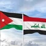 Jordan and Iraq flags waving side by side in a cloudy sky.