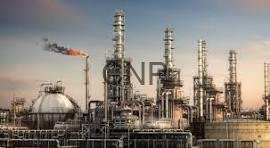 mesf - Center News Network Oil refinery complex with tall smokestacks, distillation towers, and a network of pipes against a clear sky