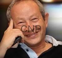 sawers - Center News Network Smiling man on a mobile phone, talking, in a casual black shirt.