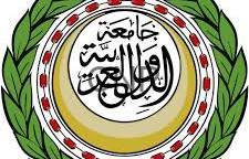 image - Rakeen News Circular emblem featuring Arabic calligraphy in the center, surrounded by a gold ring, red dot motif, and a green laurel border comma decorative insignia of Islamic origin.
